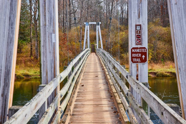Wooden suspension bridge over the Manistee River Trail